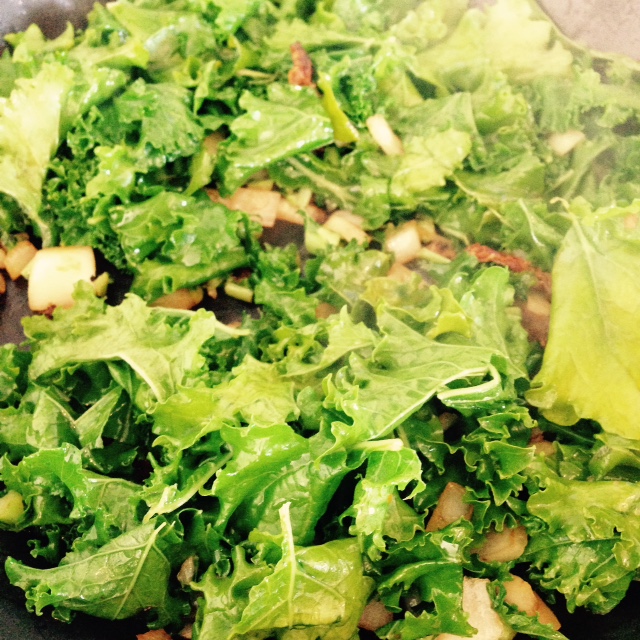 Add kale leaves and red bell peppers towards the end of the cooking process